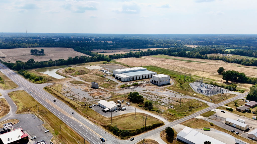 Aerial overview of the industrial complex and adjacent substation